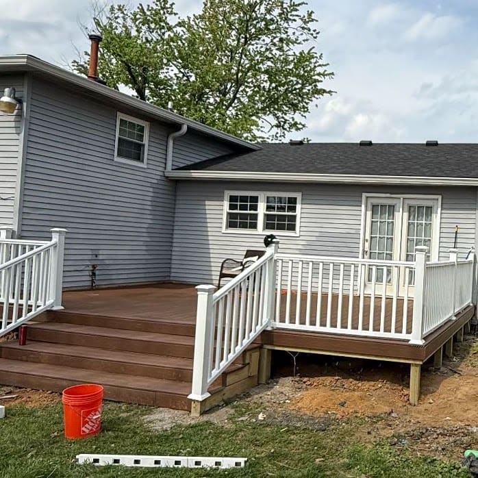 Completed backyard deck with white railing