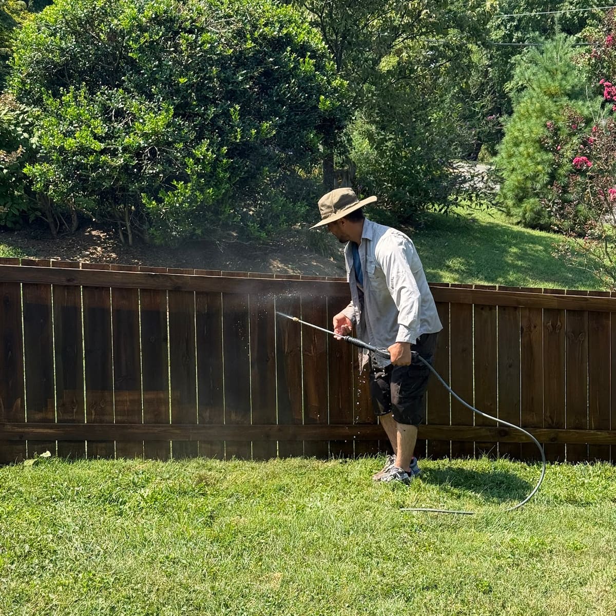 Pressure washing a wood fence before staining